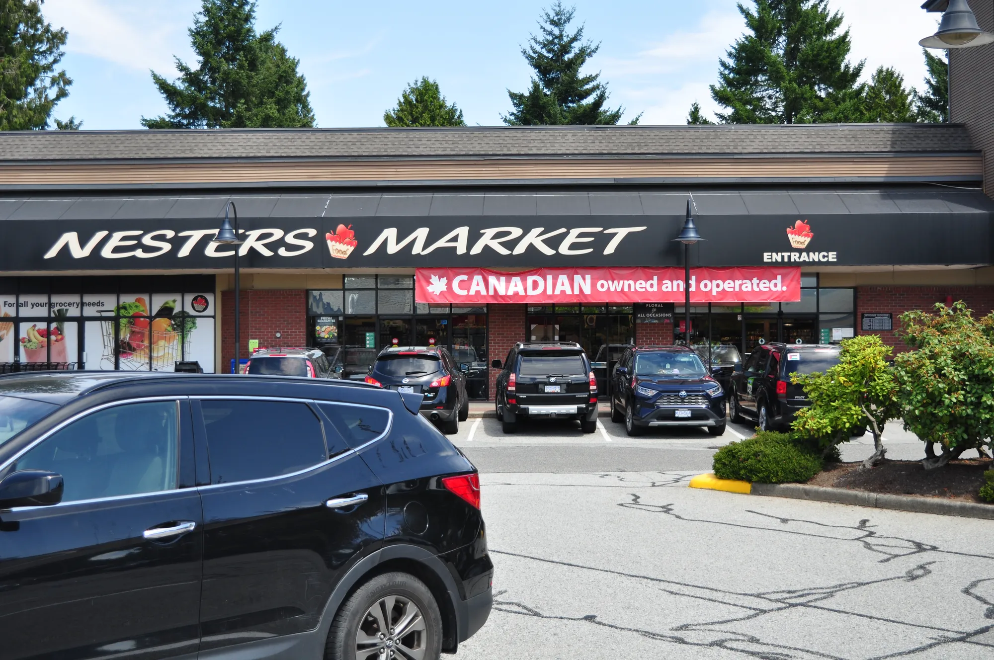 Nesters Market channel-letter fascia sign with banner in Vancouver