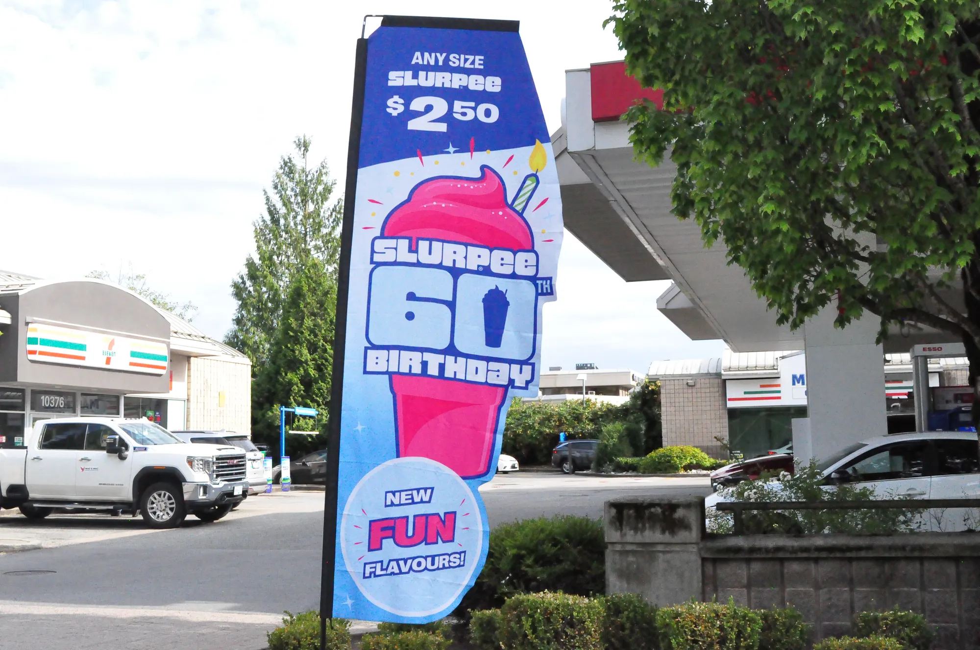 7-Eleven Slurpee feather-flag banner at a Vancouver forecourt