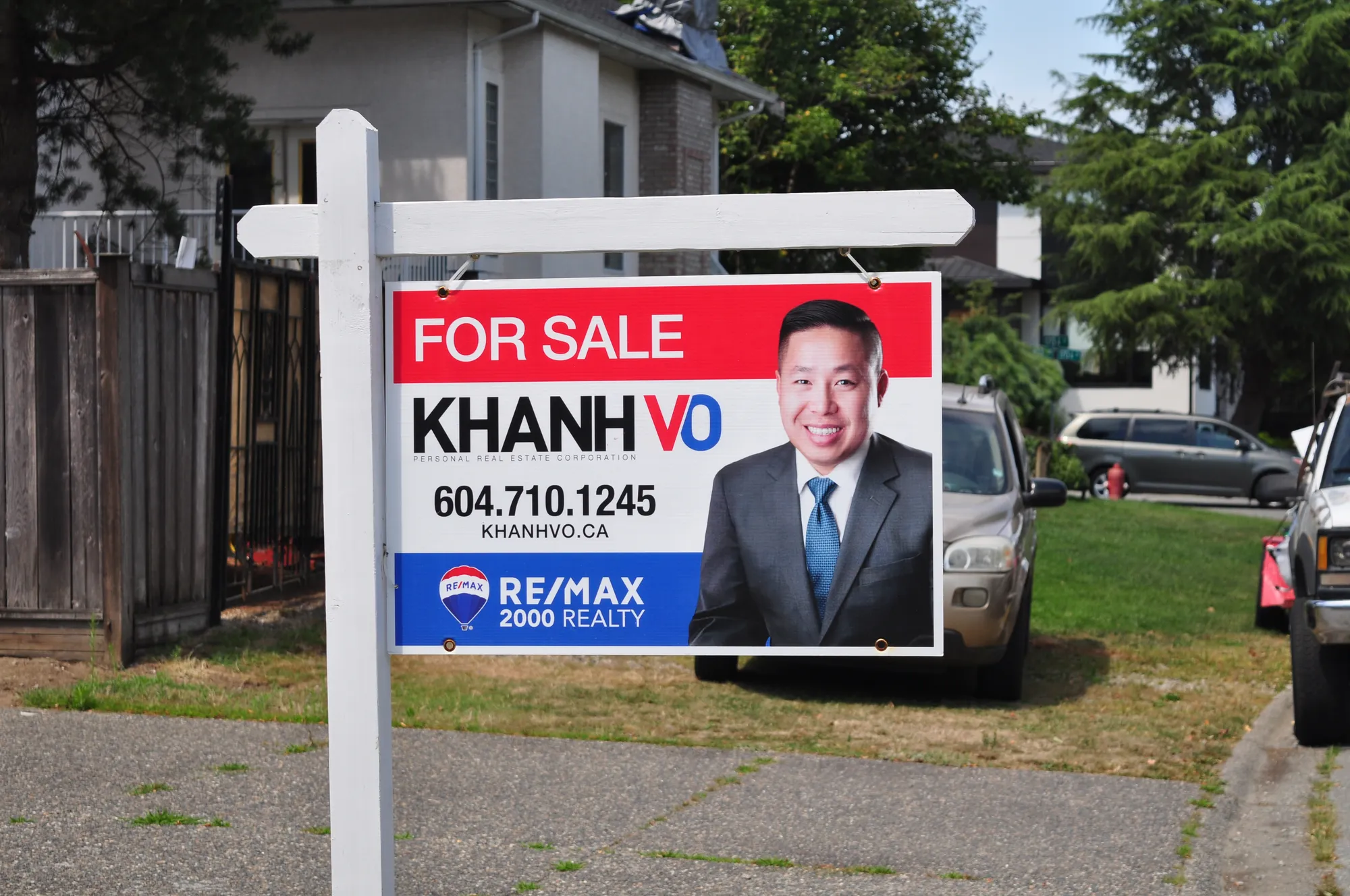 RE/MAX for-sale realtor post sign on a Vancouver residential lawn