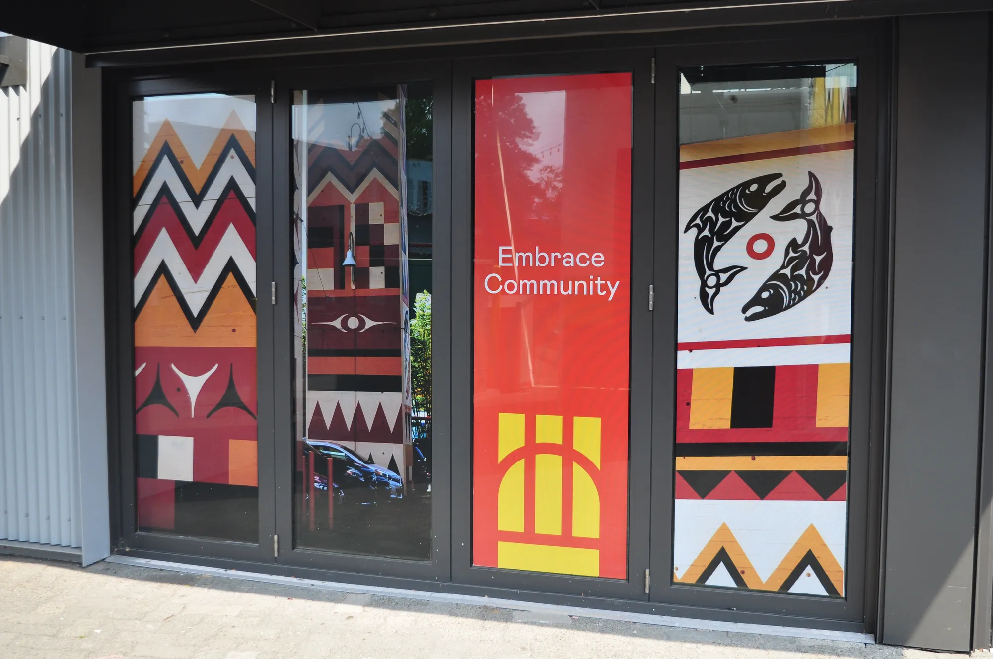 Indigenous-style 'Embrace Community' window graphics in Vancouver
