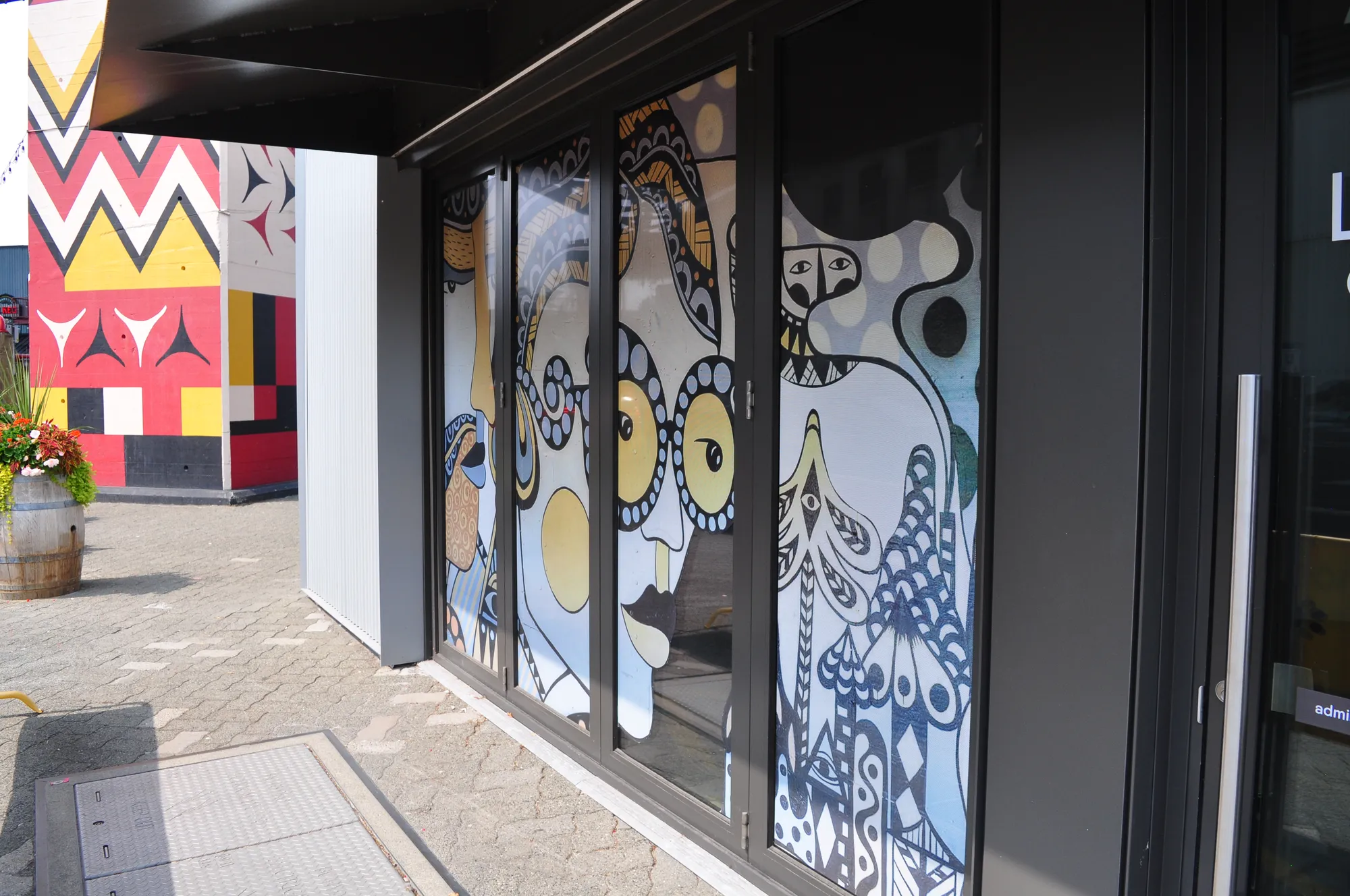 Full-colour illustrated window graphics on a Granville Island storefront in Vancouver