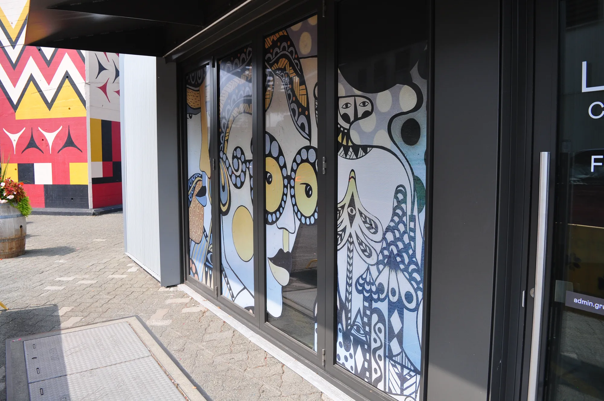 Illustrated large-format graphic wrap along a Granville Island storefront in Vancouver